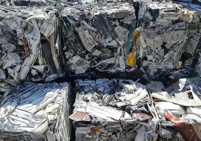 Compressed aluminium scrap packages showing consolidated sheet and profile material