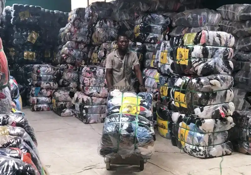Clothing bales arranged around a handling trolley