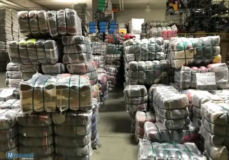 Wrapped and strapped clothing bales arranged in storage